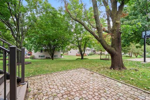 Spacious paver patio overlooks mature trees and uninterrupted greenspace.