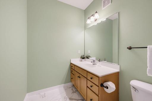Large powder room conveniently located just off the kitchen.