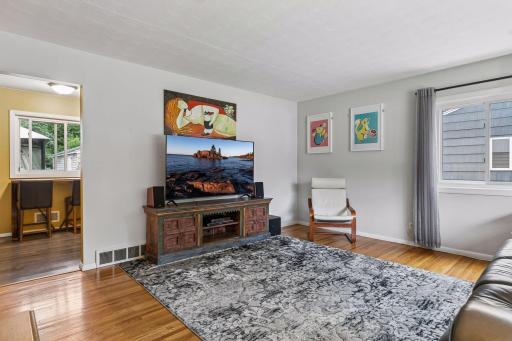 18x15 main Floor living room with Hardwood floors and fresh paint. South and west-facing windows.