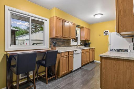 17x8 Main floor Kitchen with oak cabinets, laminate flooring and East-facing windows
