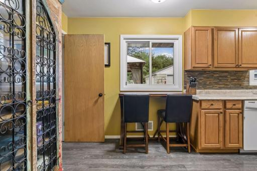 17x8 Main floor Kitchen with oak cabinets, laminate flooring and East-facing windows