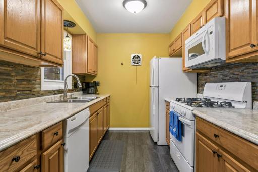 17x8 Main floor Kitchen with oak cabinets, laminate flooring and East-facing windows