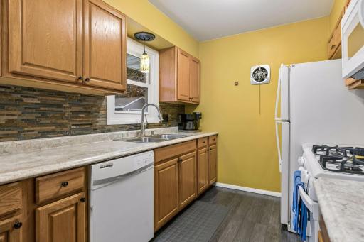 17x8 Main floor Kitchen with oak cabinets, laminate flooring and East-facing windows