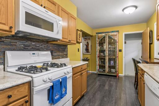 17x8 Main floor Kitchen with oak cabinets, laminate flooring and East-facing windows