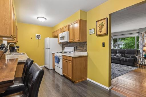 17x8 Main floor Kitchen with oak cabinets, laminate flooring and East-facing windows