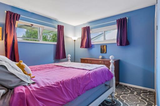 13x11 Main floor Bedroom #1 with hardwood floors, fresh paint and west and north-facing windows.