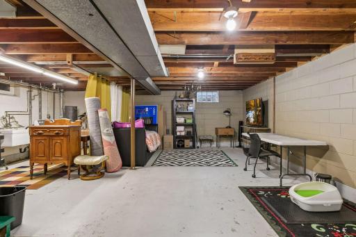 Lower-level unfinished Full Basement with Laundry and a washing sink plus an east-facing egress window. Ready for your finishing ideas.