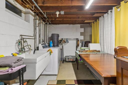 Lower-level unfinished Full Basement with Laundry and a washing sink plus an east-facing egress window. Ready for your finishing ideas.