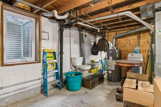Lower-level unfinished Full Basement with Laundry and a washing sink plus an east-facing egress window. Ready for your finishing ideas.