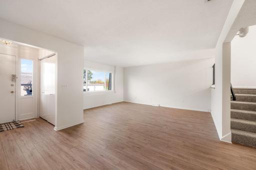 Versatile, sunlit living room with oversized window.