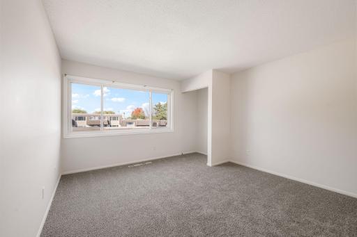 Spacious primary bedroom with brand new carpet.