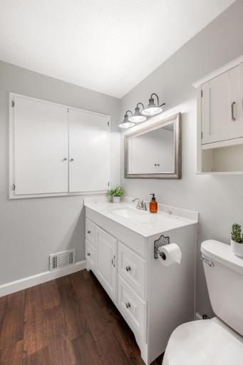 Large upper level full bathroom with oversized vanity & built-in linen storage.