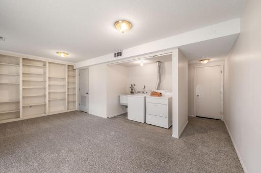Designated laundry space with convenient utility sink.