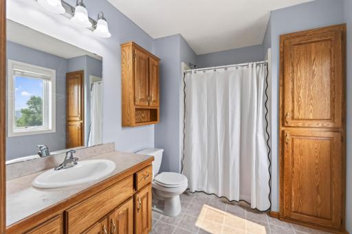 Expanded primary 3/4 bath with built in linen closet, medicine cabinet and new Andersen renewal single casement window.