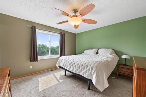 The primary bedroom upstairs with new carpeting and updated Andersen renewal glider window.