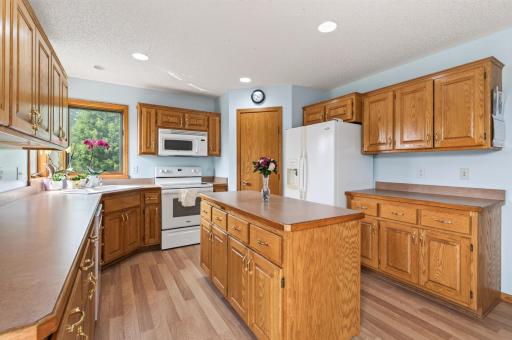 Lots of custom built oak cabinetry, center island and a walk in pantry closet.