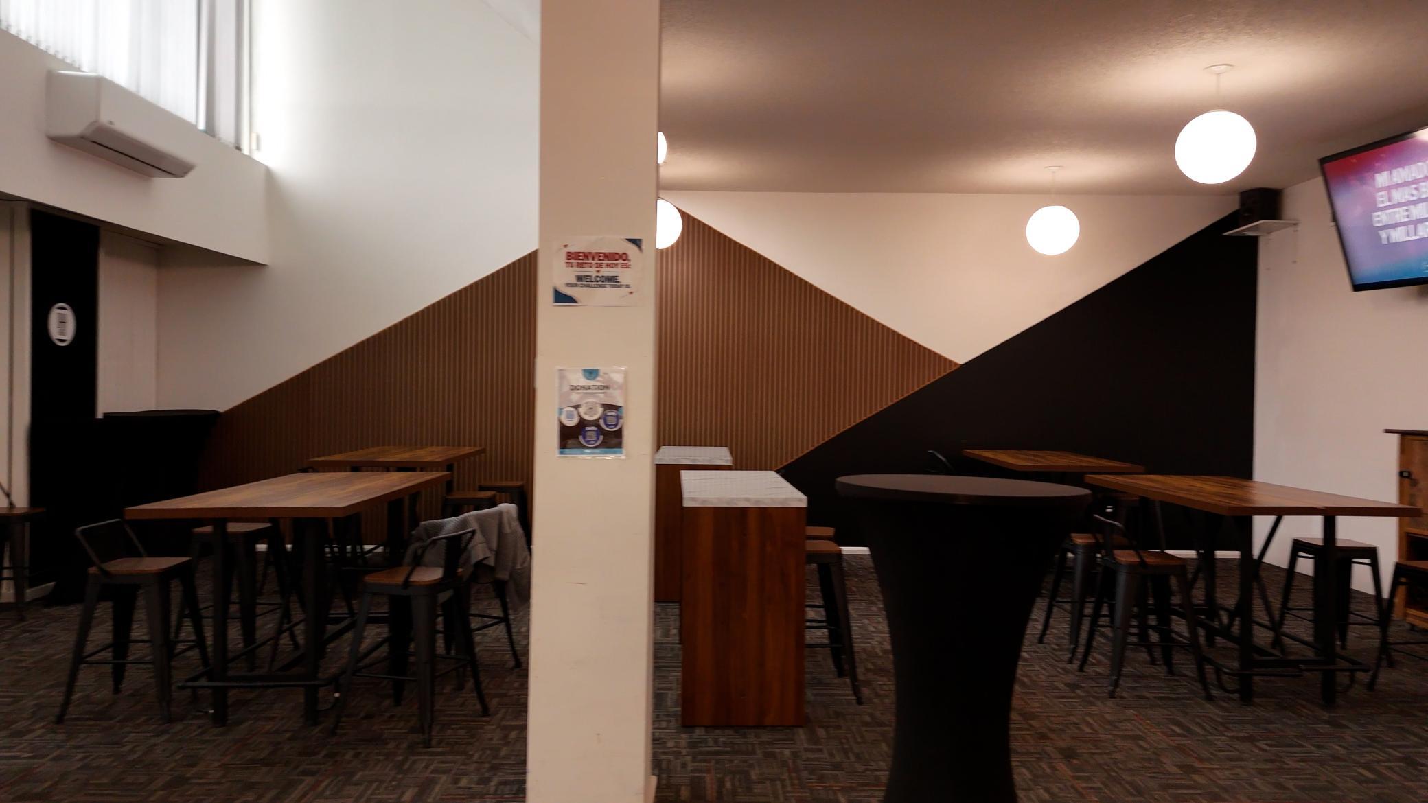 Gathering space outside Sanctuary with tables and screens to watch service or stream content.