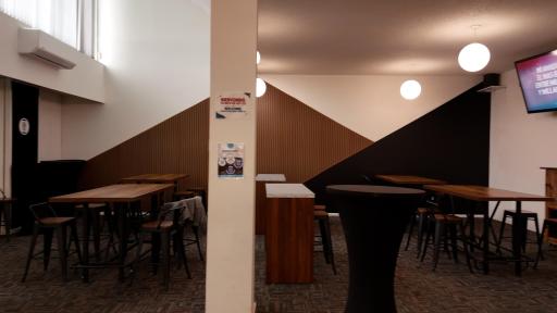 Gathering space outside Sanctuary with tables and screens to watch service or stream content.