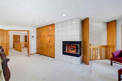 Upper Level Owner's Suite Features a Fireplace, Built-ins, and an Overlook of the Living Room that can be Opened Up or Closed for Privacy!