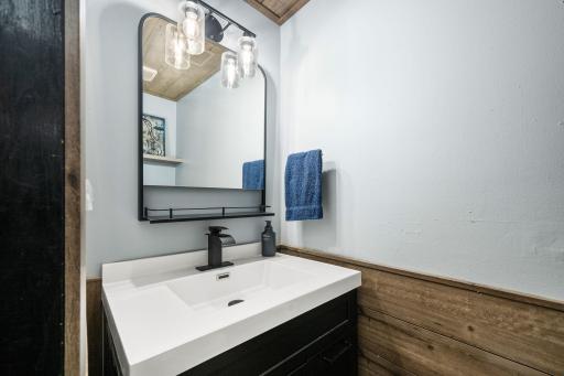 Lower level bathroom accented with ship-lap and a newer vanity