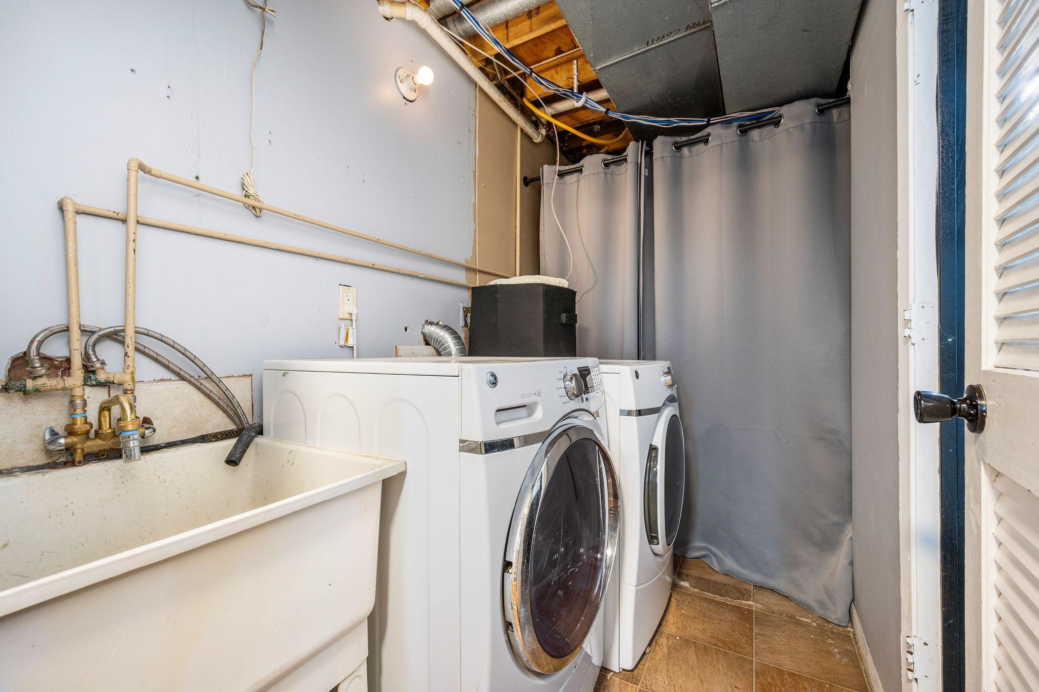 Lower level laundry room with utility sink