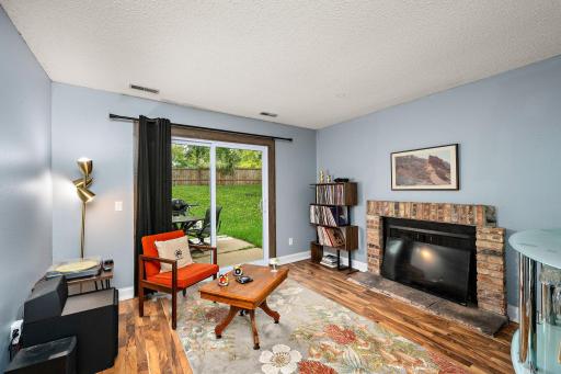 The walkout lower level features a family room, 3rd bedroom, wood-burning fireplace, storage area, laundry room with a utility sink, and a bathroom accented with ship-lap and a newer vanity.
