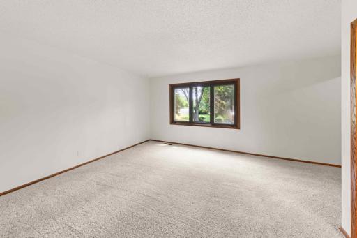 Generously sized owner's suite with fresh neutral finishes, new carpeting and a large window for natural light