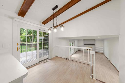 Sun-filled breakfast nook overlooking the family room and opening directly to the deck