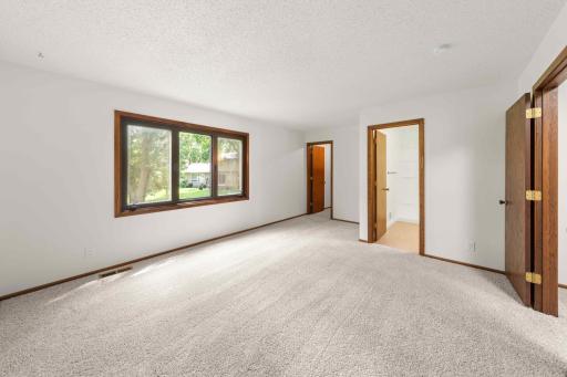 Primary bedroom with abundant natural light, and convenient access to the private bath and walk-in closet