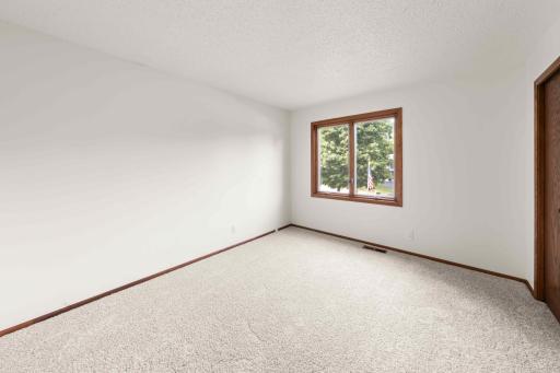 Third bedroom upper-level with new carpeting and natural light from a large window