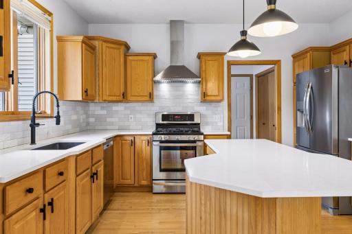 Efficient layout with a center island, two pantries, and adjacent laundry/mudroom.