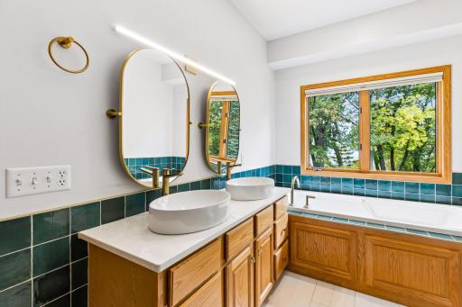 New countertop, Kohler vessel sinks, mirror and lighting. AND new tile flooring.