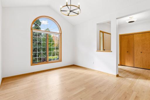 Front formal vaulted dining room with half circle window accent. AND brand new light fixture!