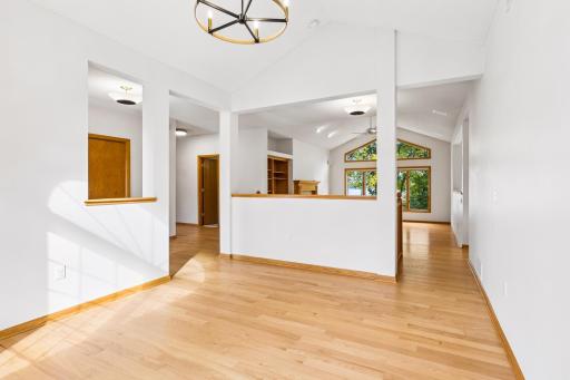The dining room and main floor living spaces all offer hardwood floors. From the dining room you see all the way to the backyard.