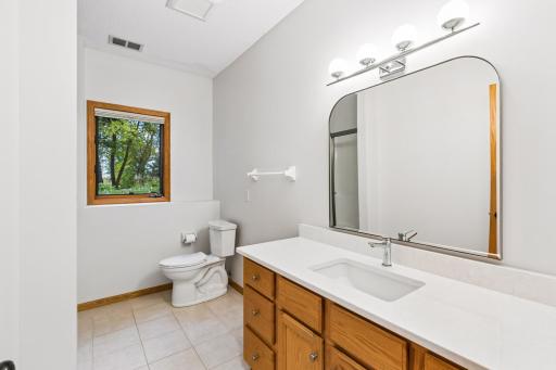 Lower level 3/4 bath with new countertop, sink and fixtures.
