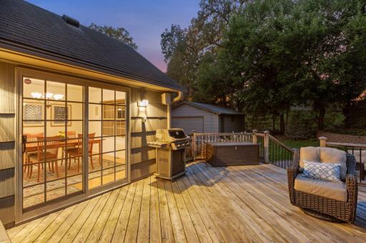 Large deck off of patio doors viewing private rear yard.