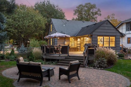 Beautiful outdoor space with paver patio just steps down from entertainment sized deck