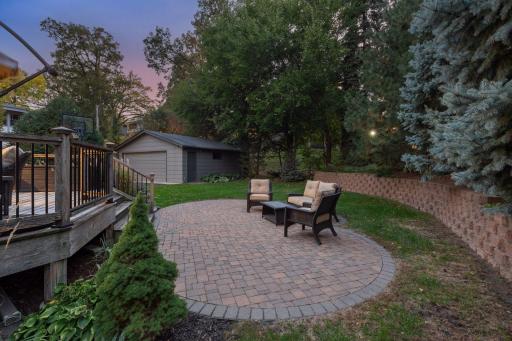 Paver patio extends from the large deck.