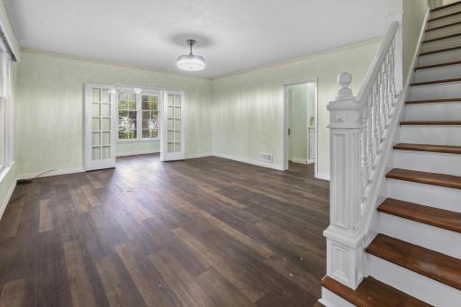 large living room with french doors to the sunroom