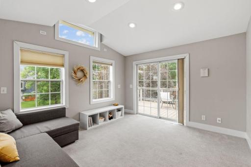 large sunroom with patio door leading to deck