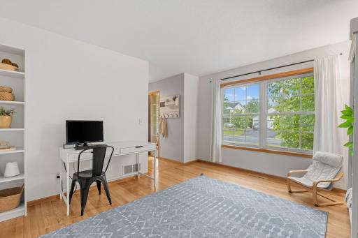 another angle of large main floor office with large windows facing driveway