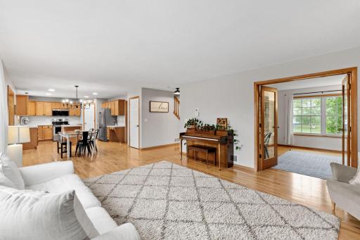 living room looking onto kitchen and main floor office with french doors open