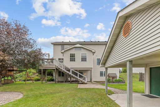 view of back deck and sunroom from standing by outbuilding