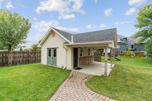 outbuilding on the property with covered porch