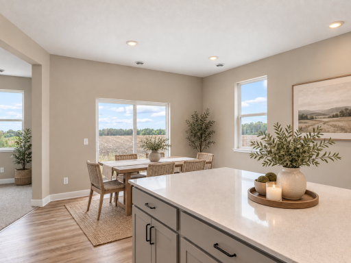 Large island overlooks the LARGE dining room. *Photo of similar home. Virtually staged.