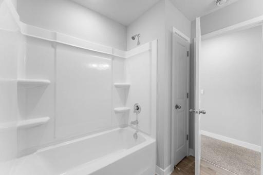 Upper level main full bathroom. *Photo of similar home. Virtually staged.