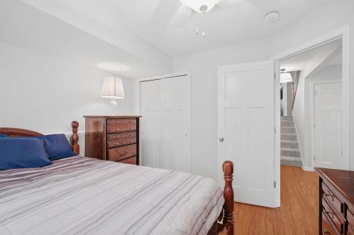 Lower level lookout bedroom with ceiling fan.