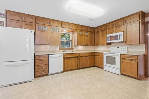 Granite countertops and detailed glass accents on a few of the cupboard doors