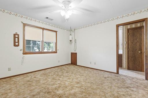The main floor bedroom features walk-through access to the main floor bathroom