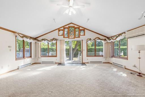 This sunroom is absolutely stunning! Showcasing vaulted ceilings, spotlights, patio access to the private backyard, and stained glass window centerpiece placed on the east side of the home to let the sunrise shine through.